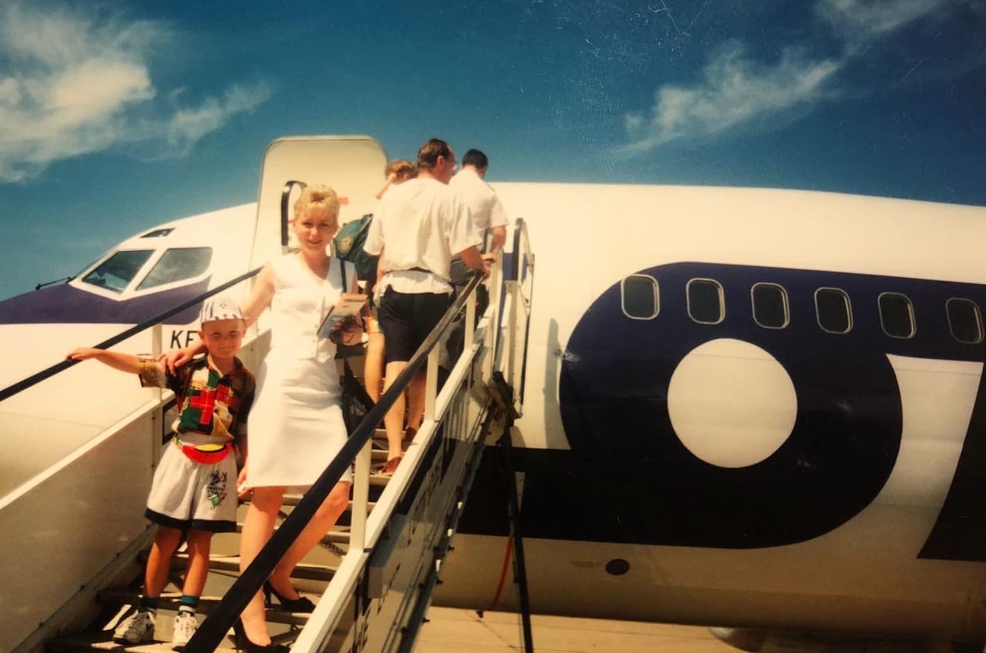 Jake as a boy with his mother on the airstairs of a Boeing 737, 1995